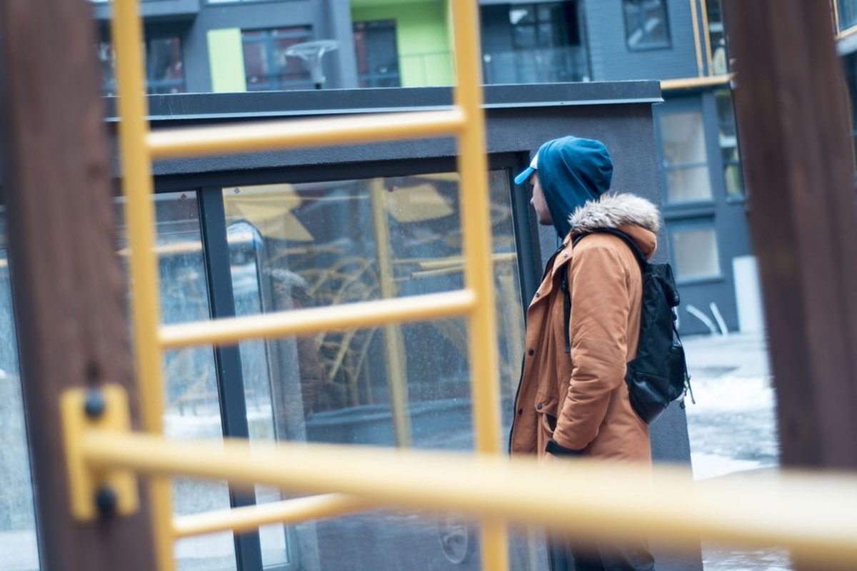 Young man walks in the city example image 1