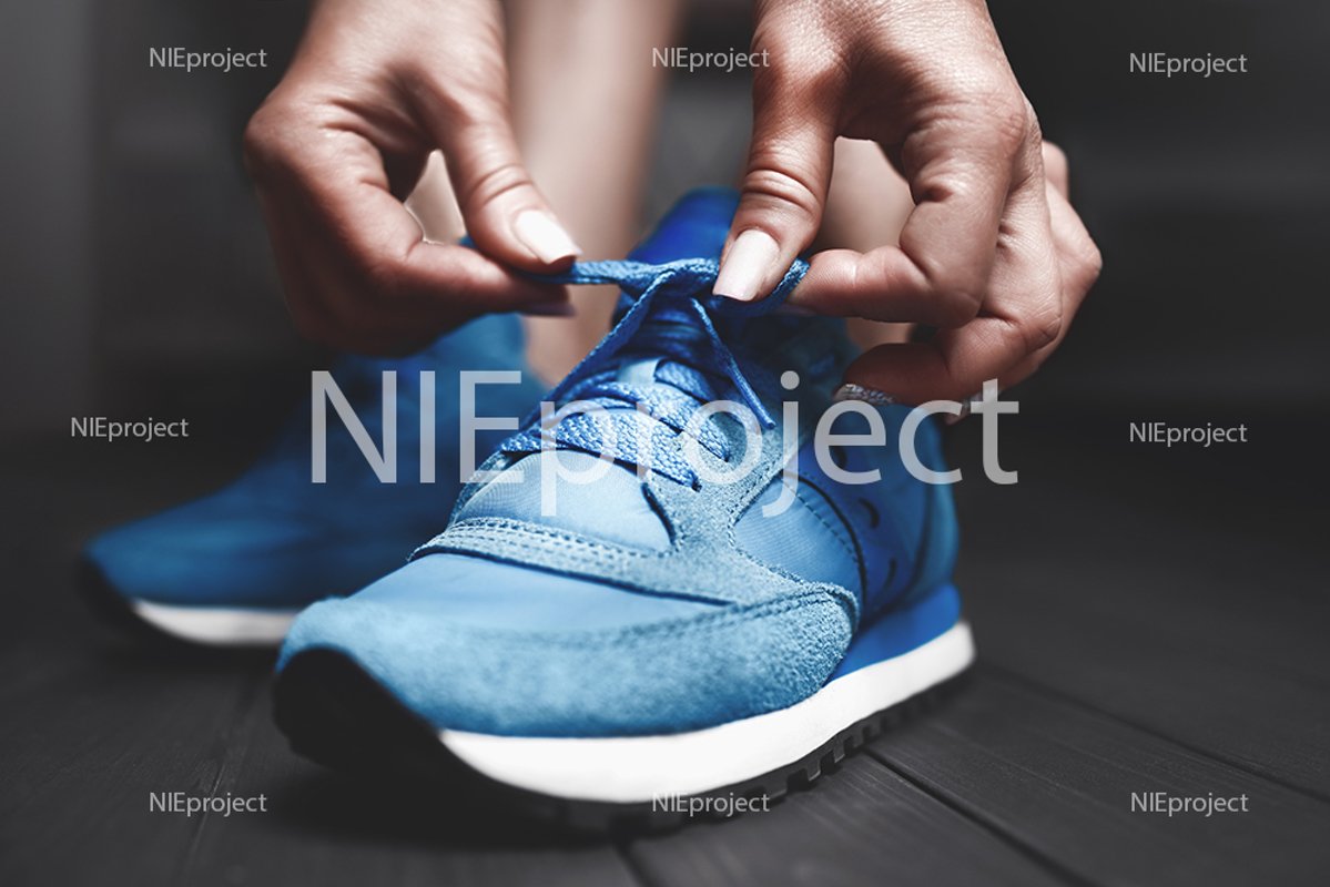 The girl measures new sports sneakers in the dressing room. example image 1