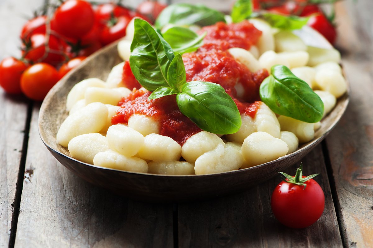 Italian gnocchi with tomato and basil, selective focus example image 1