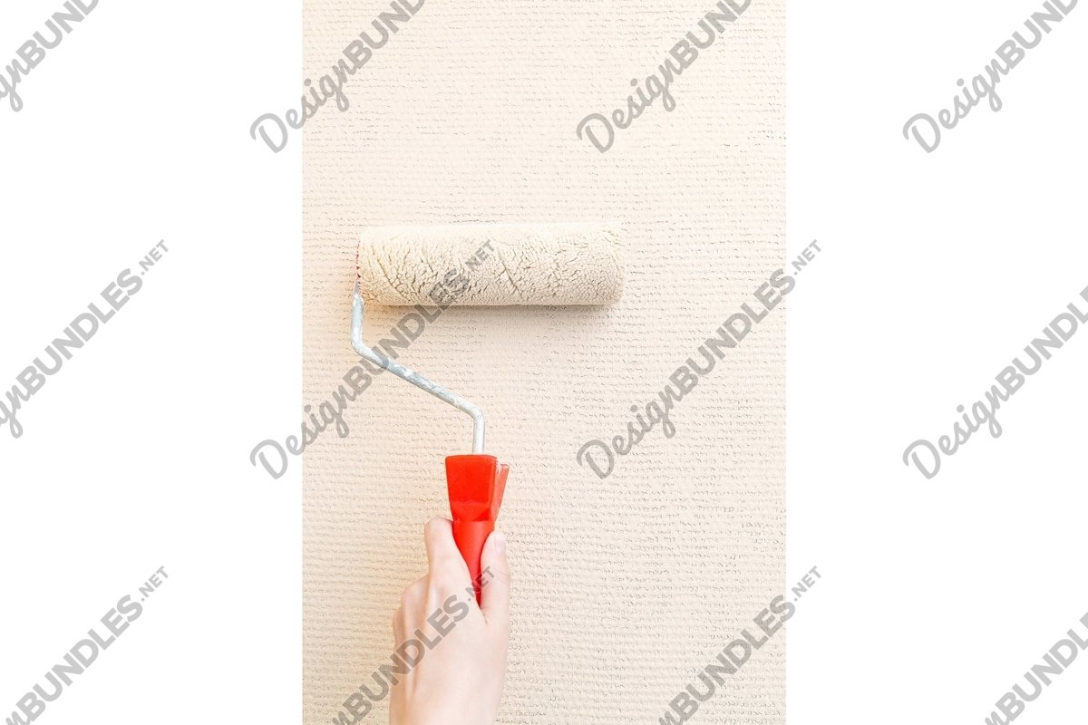 Photo of a hand with a cushion paints the wall example image 1