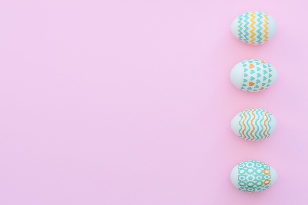 Decorated Easter eggs lie on the pink background. example image 1