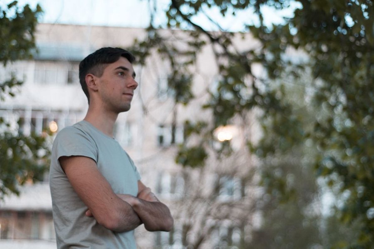 Young caucasian man walks in a park example image 1