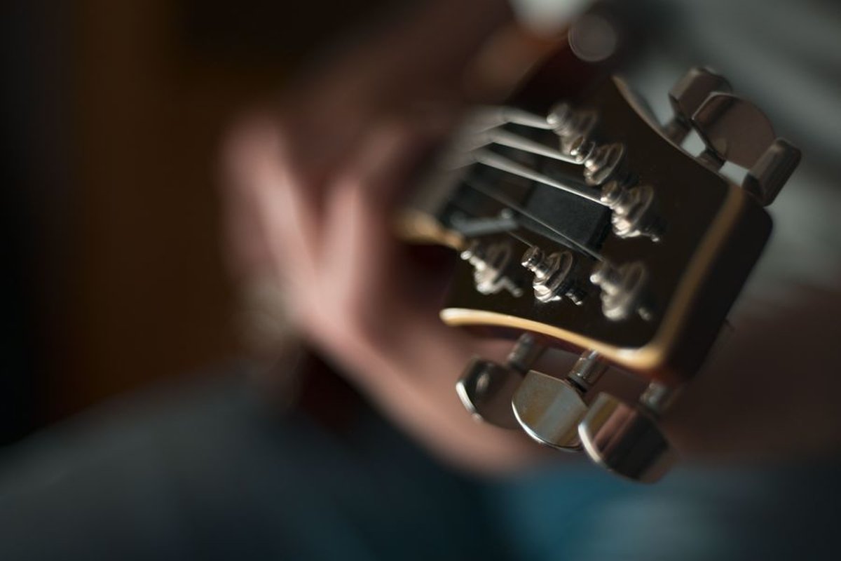 Man plays on electric guitar in studio example image 1