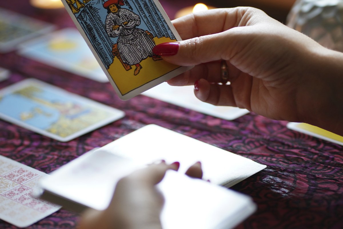 Tarot reader picking tarot cards. example image 1