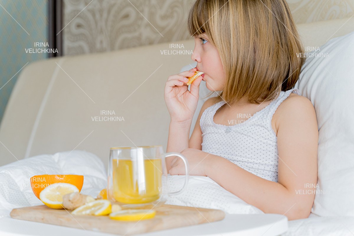 Sick girl in bed. Cup of flu drugs. Tea, orange,lemon,ginger example image 1