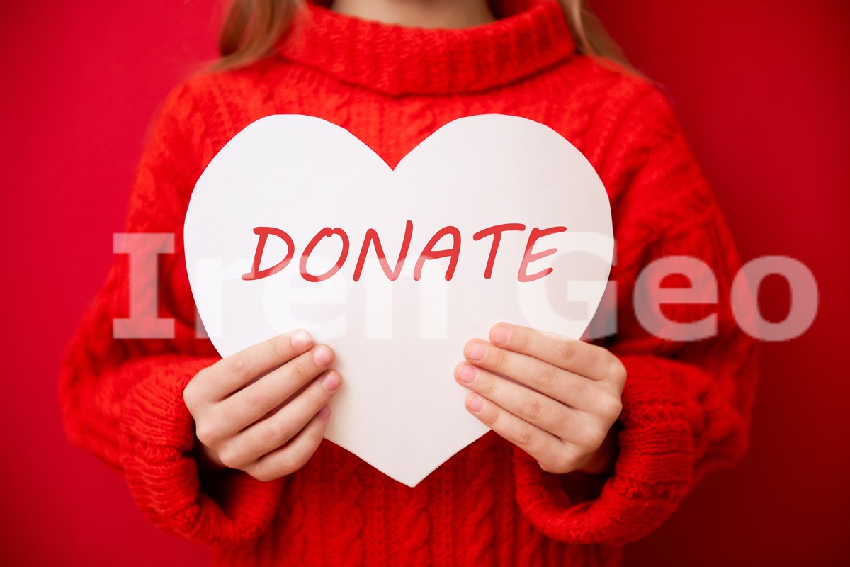 Lovely little girl holding large paper heart, over red example image 1