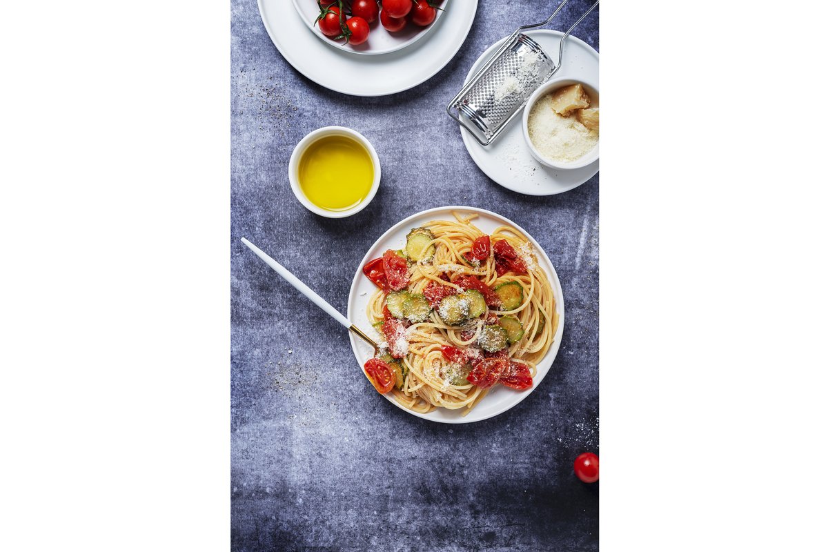 Traditional Italian pasta with tomato, zucchini and parmesan example image 1