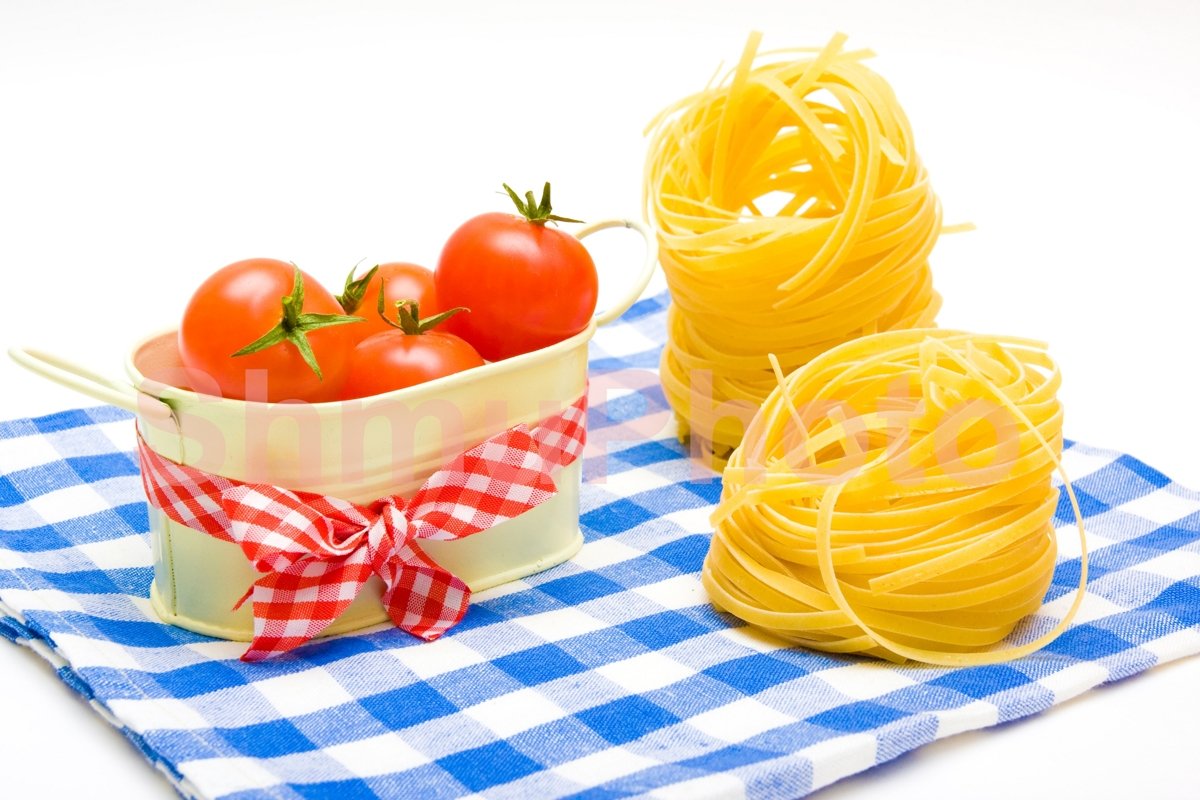 Pasta nest and tomatoes cherry on plaid napkin example image 1