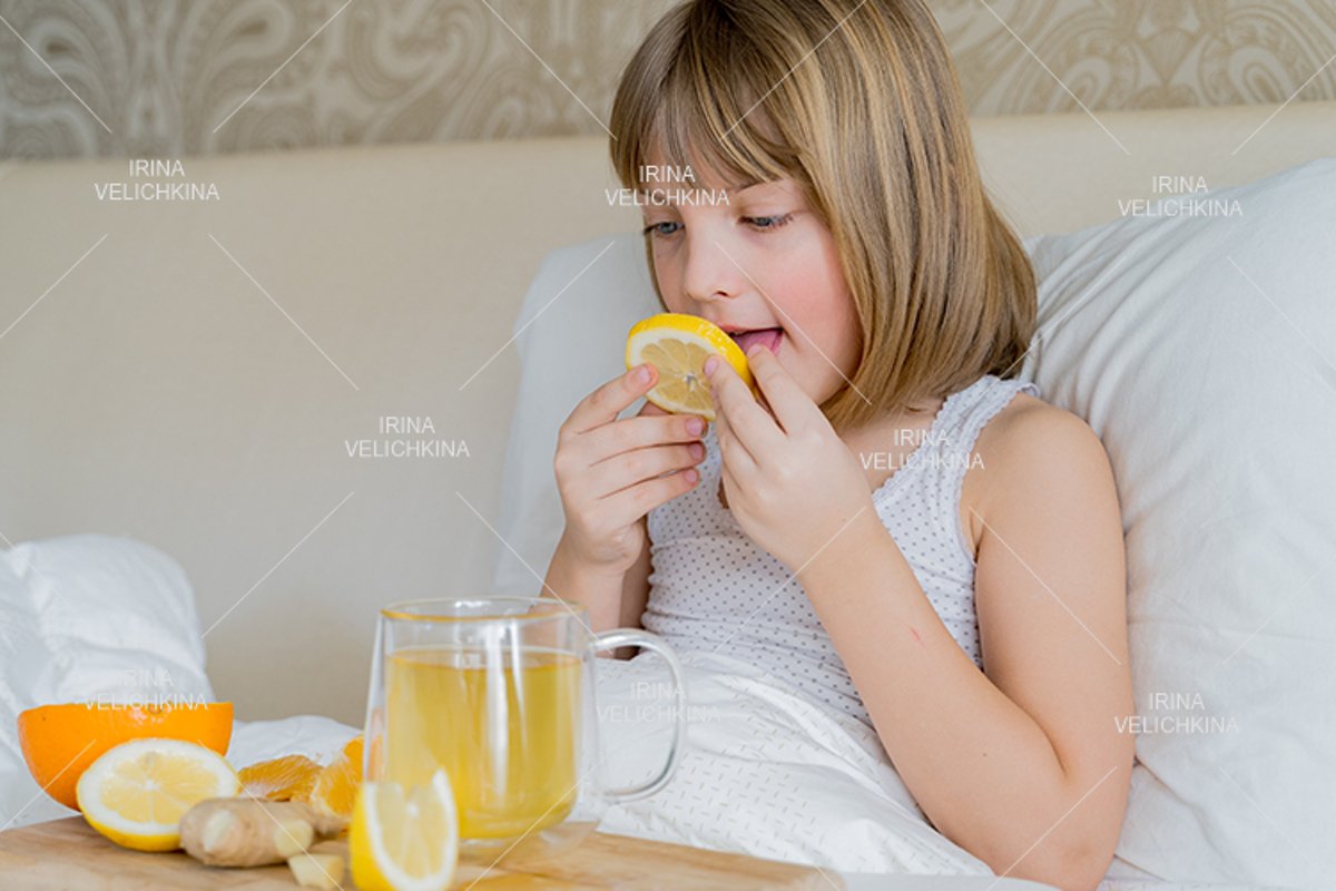 Sick girl in bed. Cup of flu drugs. Tea, orange,lemon,ginger example image 1