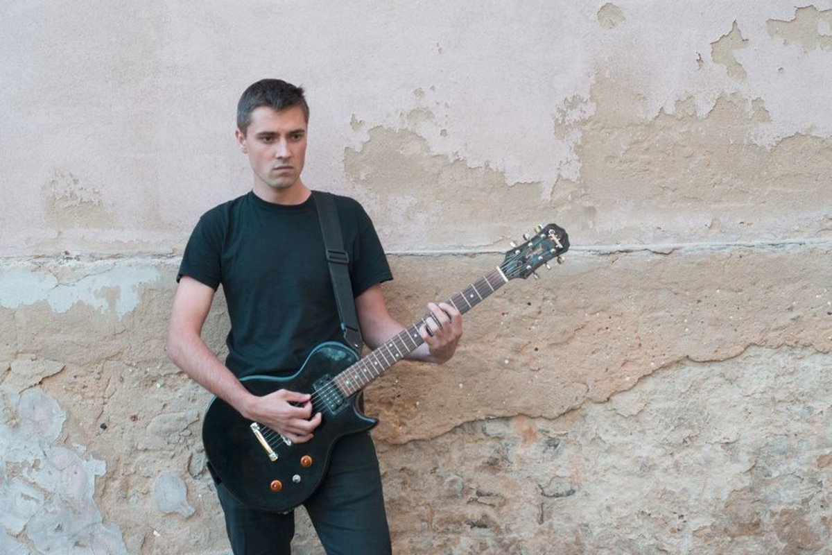 Young caucasian man with electric guitar example image 1