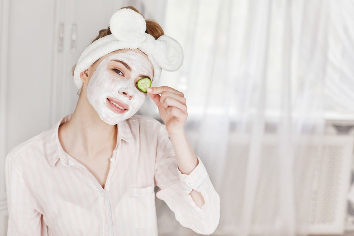 Girl with a face mask and slices of cucumber example image 1