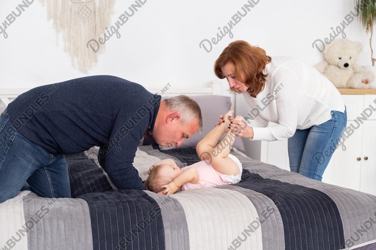 Family - grandmother, grandfather and granddaughter indoors example image 1