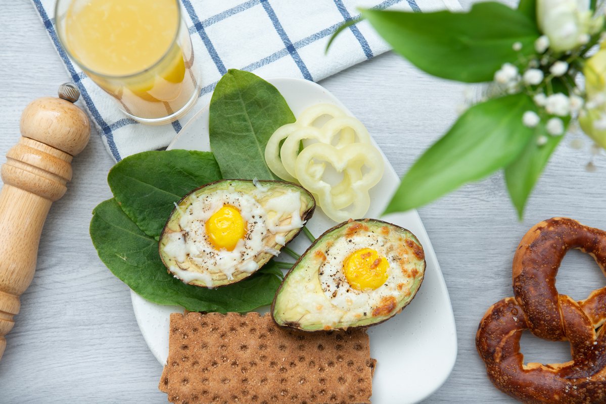flat lay eggs baked in avocado on plate example image 1