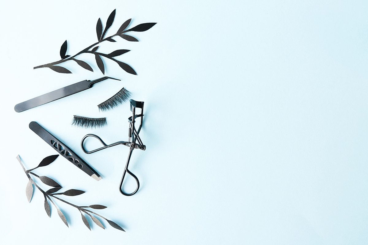 False lashes with black tweezers and paper leaves example image 1