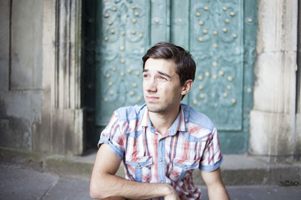 Young man walks in the city example image 1