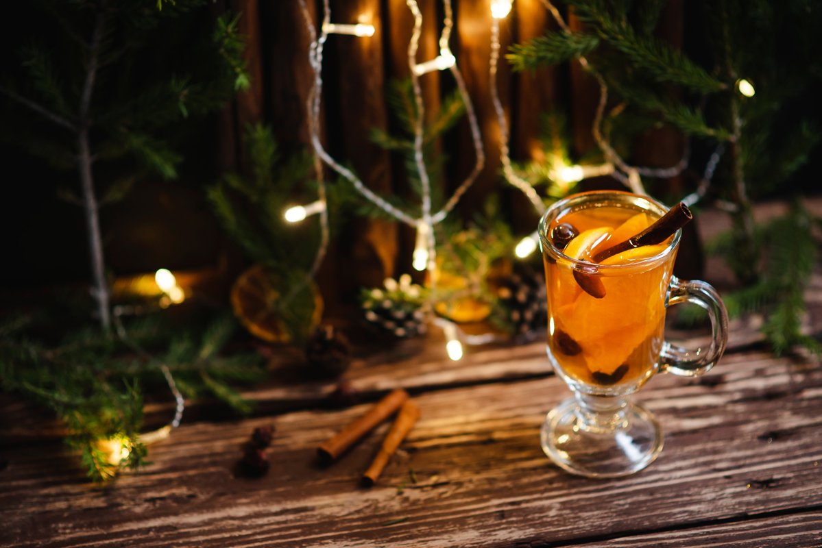Homemade tea with citrus and cinnamon on a wooden table example image 1
