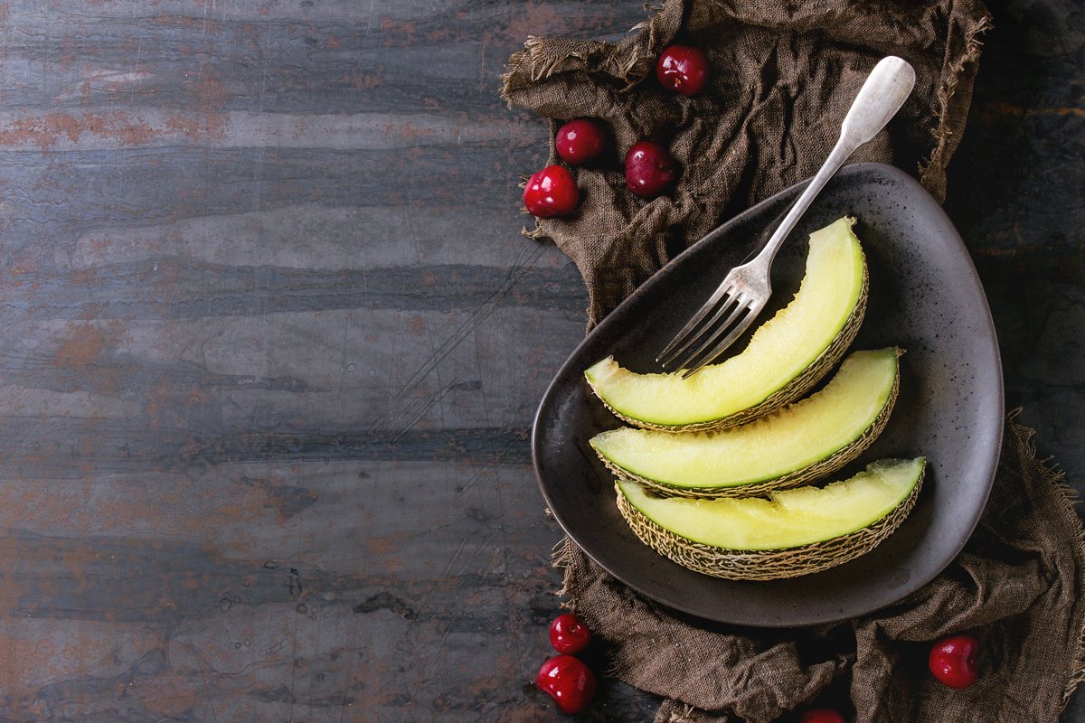 Sliced melon with cherry example image 1