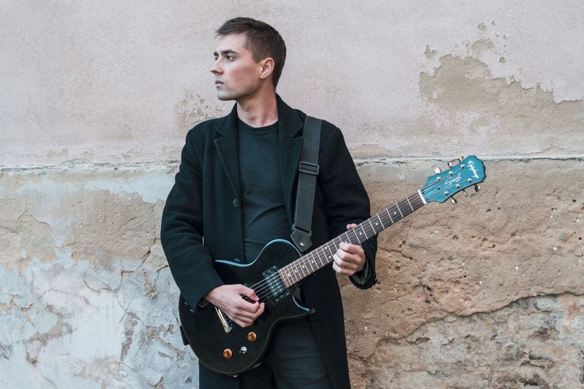 Young caucasian man with electric guitar example image 1