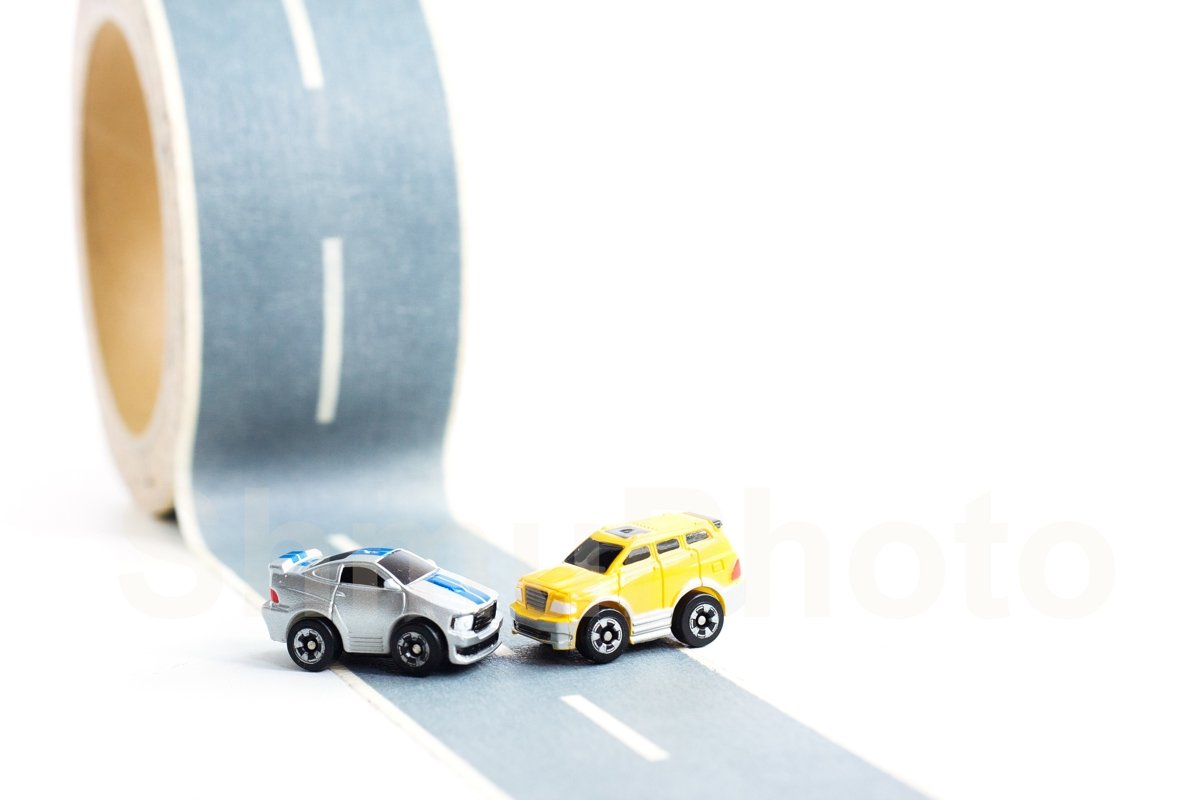 Cars accident on rough road. Two toy models on duct tape example image 1