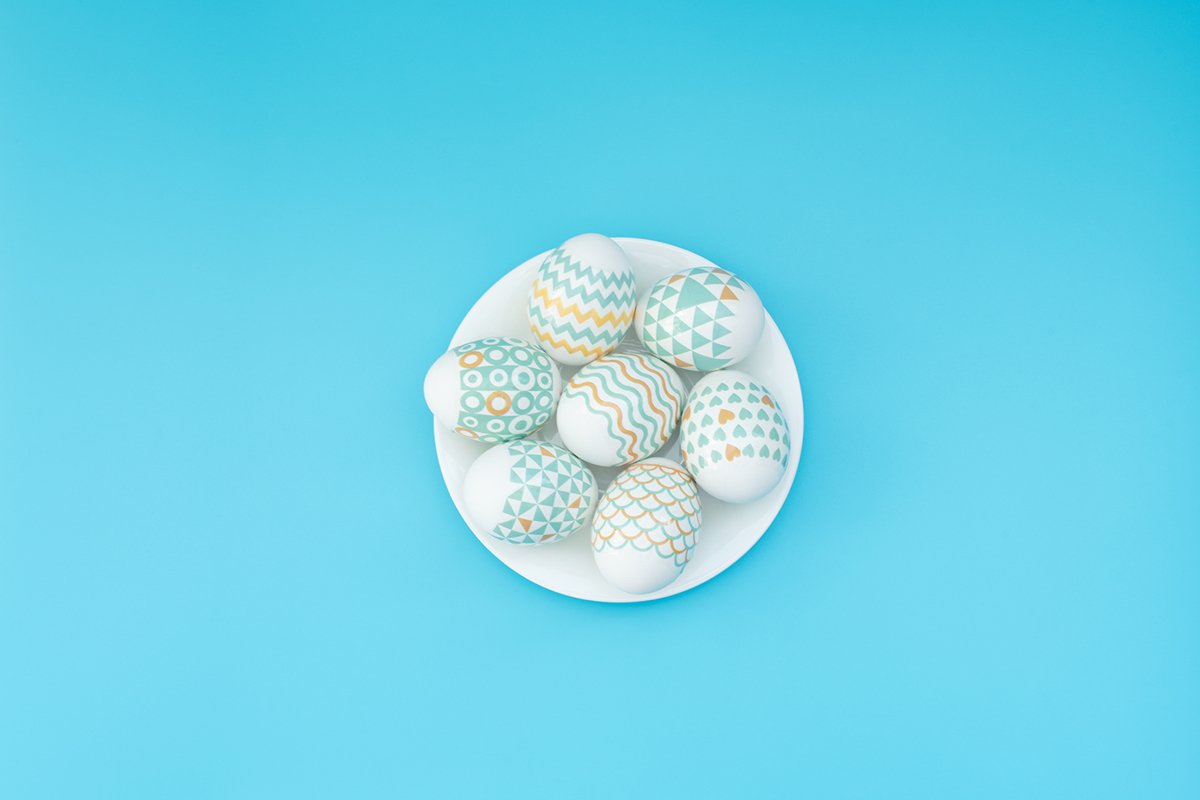 Decorated Easter eggs lie on the white plate example image 1