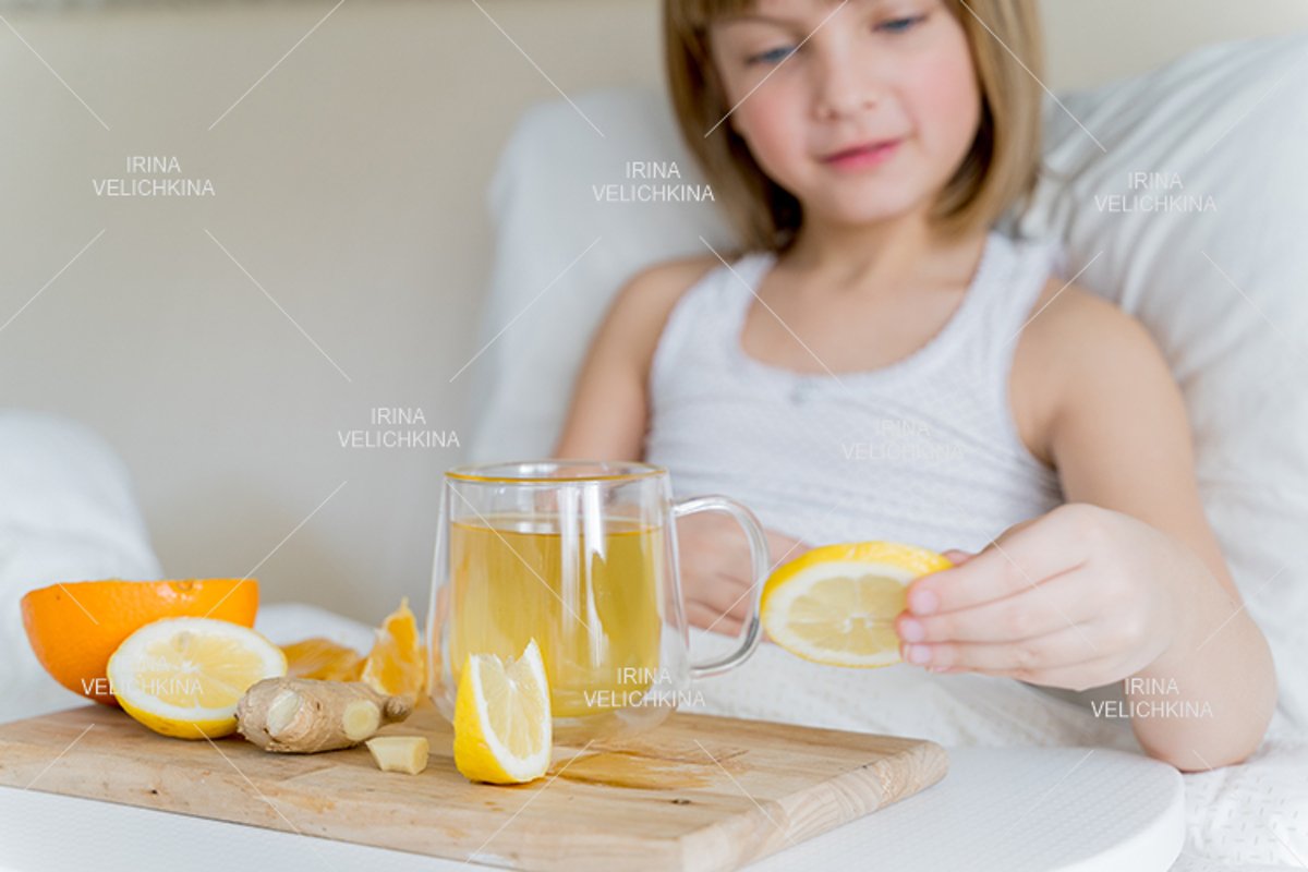 Sick girl in bed. Cup of flu drugs. Tea, orange,lemon,ginger example image 1