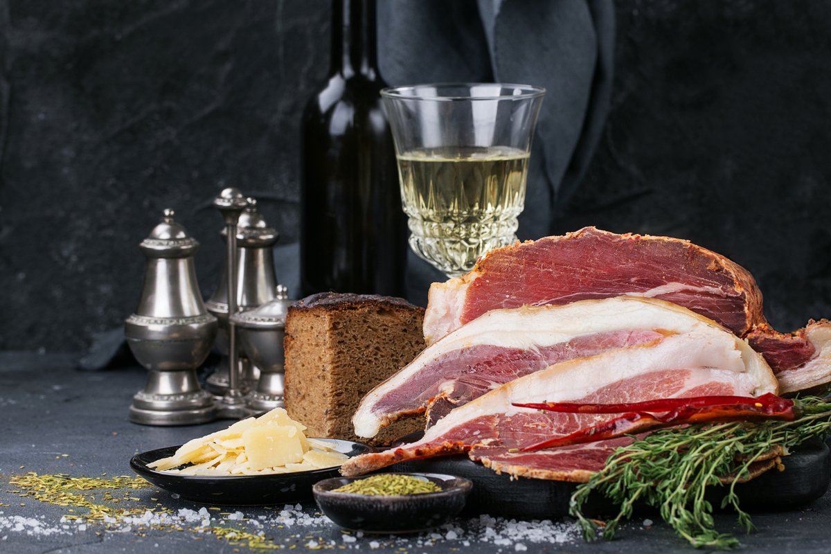 Prosciutto Ham served on a rustic wooden board example image 1