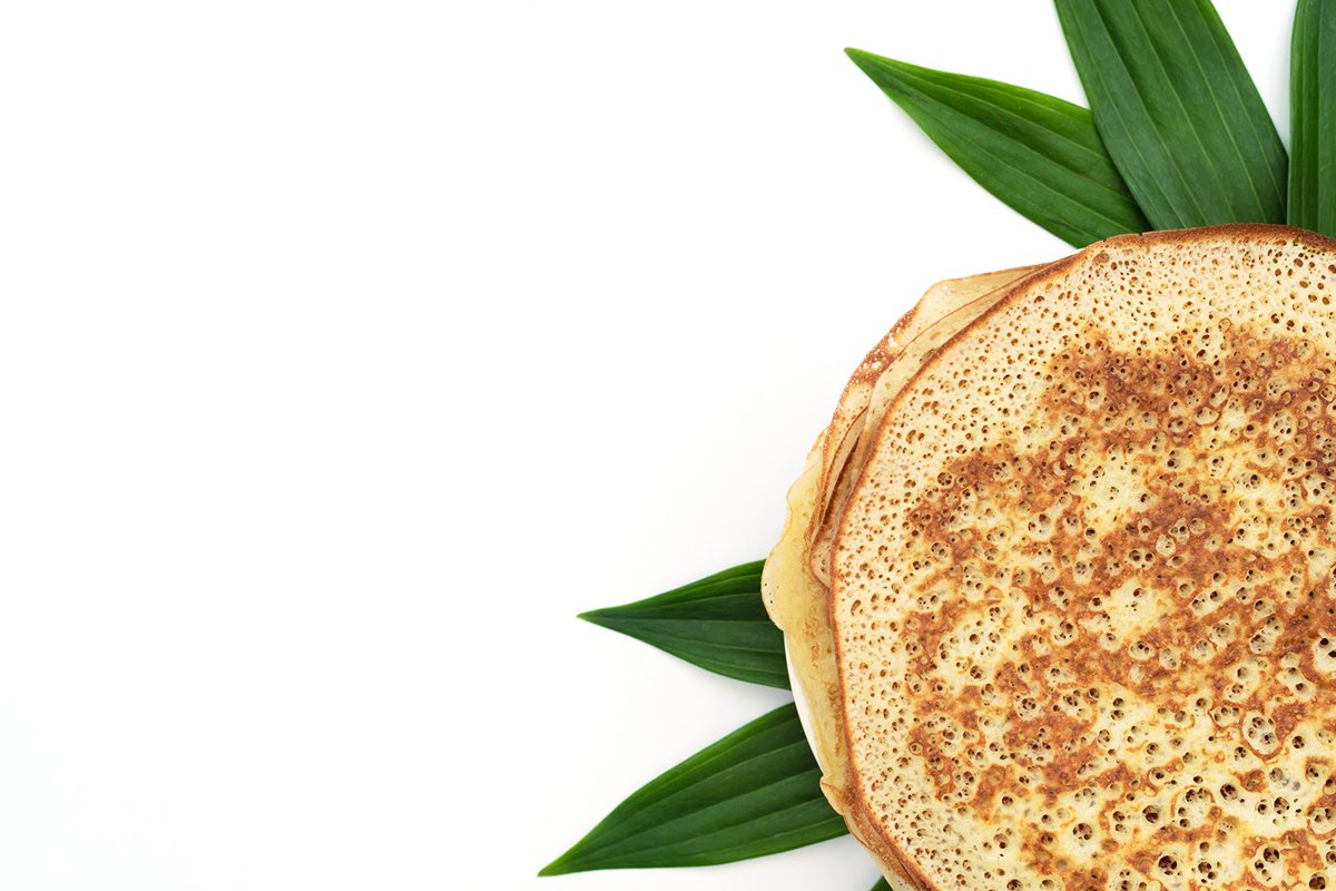 Homemade pancakes on white background with green leaves example image 1