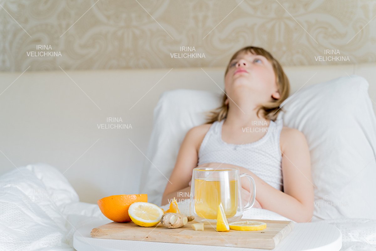 Sick girl in bed. Cup of flu drugs. Tea, orange,lemon,ginger example image 1