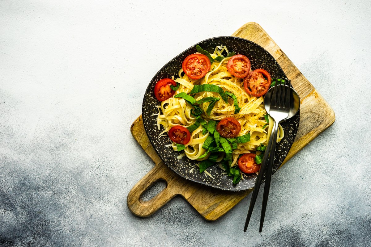 Traditional italian pasta with tomatoes and spinach example image 1