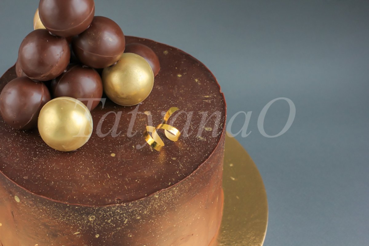 Chocolate birthday cake with gold decorations. example image 1