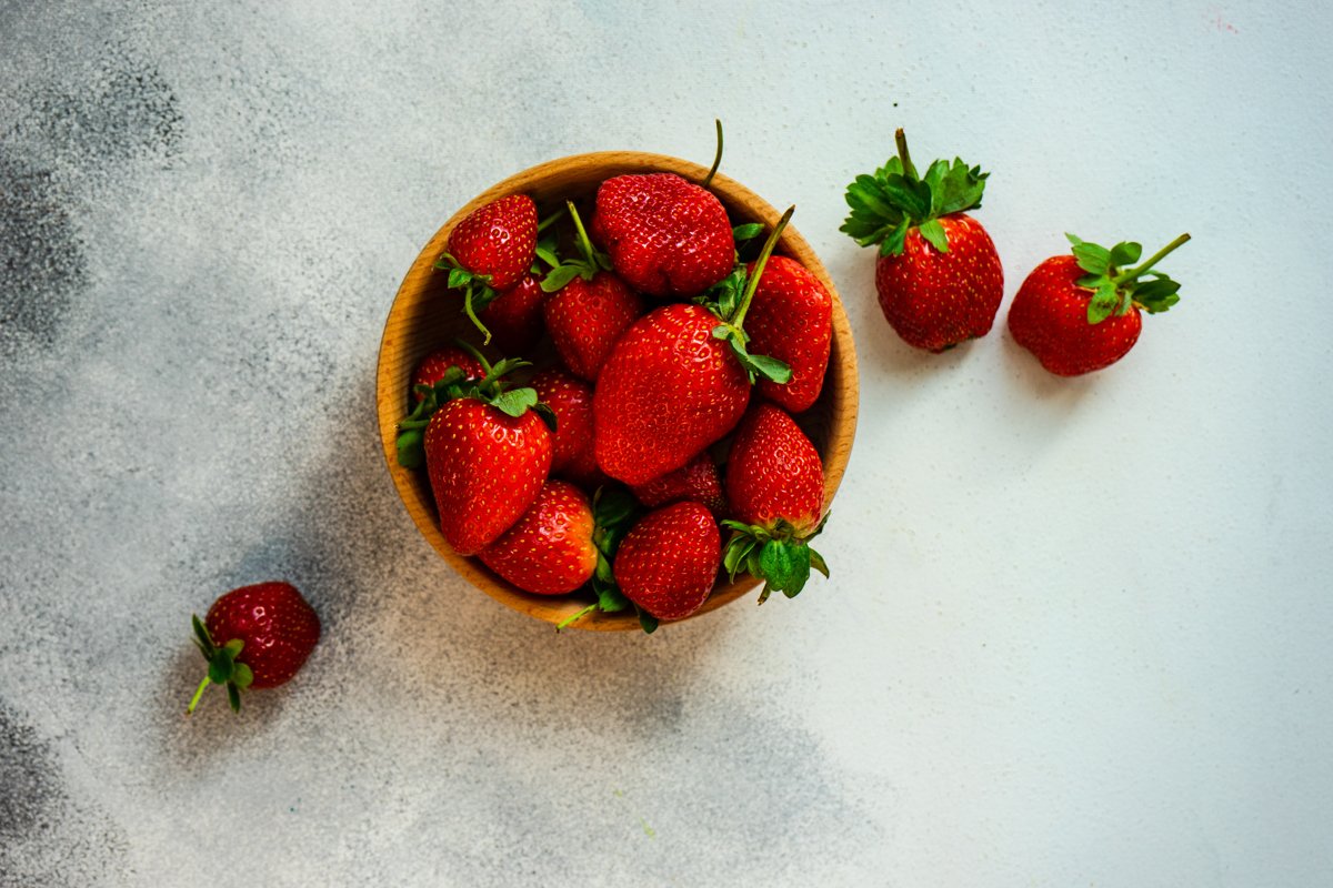Organic summer berries in wooden bowl full of strawberries example image 1