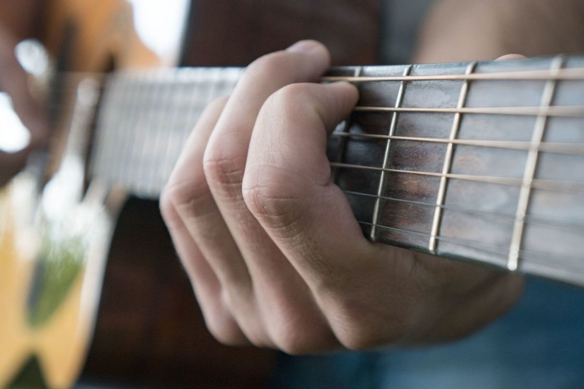 Young caucasian man with guitar in the park example image 1