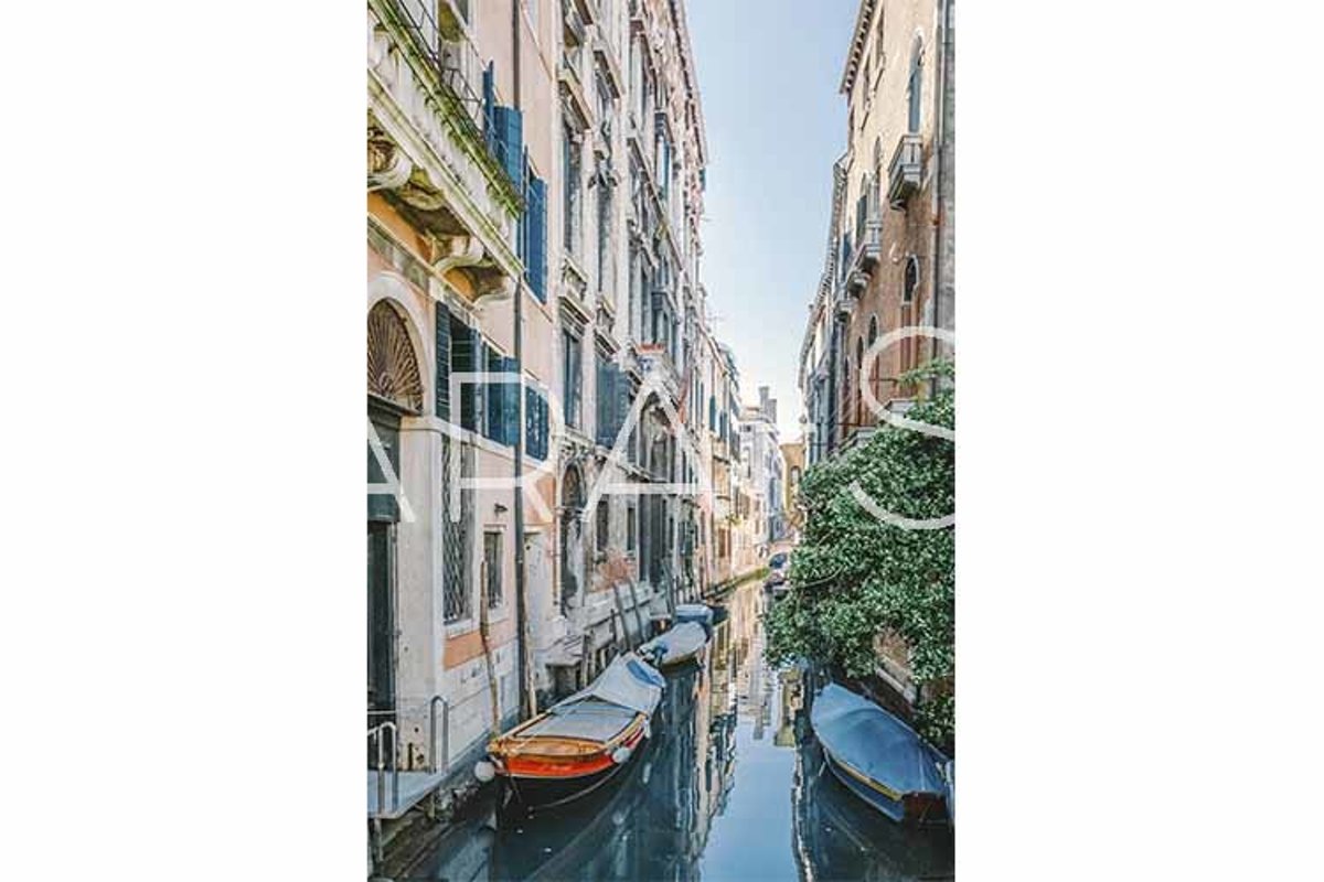 Gondolas on narrow canal in Venice, Italy. example image 1