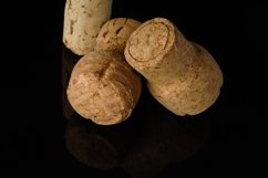 Heap of old wine corks on black background with reflection Product Image 1