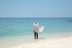 Woman looking at sea view on the beach Product Image 1