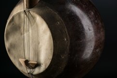 Part ancient Asian stringed musical instrument on black Product Image 1