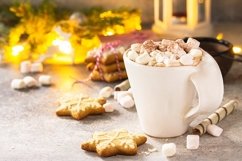 A cup of hot cocoa with marshmallows and Christmas baking. Product Image 1