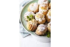 Mix of different profiteroles with cream, selective focus Product Image 1