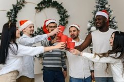 Side view. People in santa hats clink glasses Product Image 1