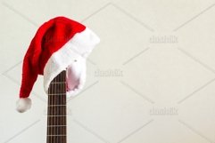 acoustic guitar with red Santa hat Product Image 1
