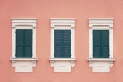 three green wooden window with shutters on pink wall Product Image 1