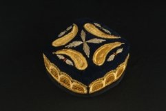 Gold colored traditional asian skullcap cap on a dark Product Image 1