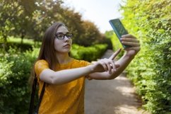 Girl in glasses with phone Product Image 1