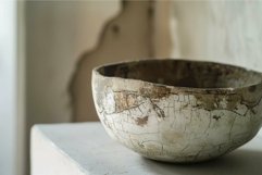 Old ceramic bowl with craquelure standing on white surface Product Image 1
