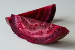 Two slices of fresh beetroot laying on a white surface Product Image 1