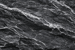 A dark gray slate rock with white veins Product Image 1