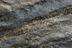 A rocky surface with gold specks Product Image 1