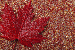 Red maple leaf covered in glitter on a sparkling background Product Image 1