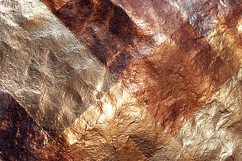 A textured, metallic surface with golden hues Product Image 1