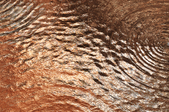 A ripples on a copper surface with a metallic sheen Product Image 1